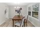 Dining area featuring modern light fixture, neutral decor, and a view to stairs at 11035 W Lakeshore Dr, Carmel, IN 46033