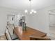 Dining area with view to the kitchen, showcasing modern lighting and neutral color palette at 11035 W Lakeshore Dr, Carmel, IN 46033