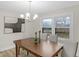 Dining room with modern light fixture, large window, and neutral color palette at 11035 W Lakeshore Dr, Carmel, IN 46033