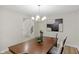 Dining area featuring modern lighting, neutral decor, and view of staircase at 11035 W Lakeshore Dr, Carmel, IN 46033