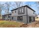 Rear exterior of a home featuring painted brick, many windows, and screened-in porch at 11035 W Lakeshore Dr, Carmel, IN 46033