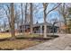 Charming gray home exterior with an open driveway, a basketball hoop, and tasteful landscaping at 11035 W Lakeshore Dr, Carmel, IN 46033