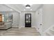 Bright and airy foyer with vinyl plank flooring, a stylish front door, and modern lighting at 11035 W Lakeshore Dr, Carmel, IN 46033