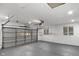 Spacious garage with epoxy flooring and a window offering natural light at 11035 W Lakeshore Dr, Carmel, IN 46033