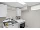 Laundry room area features washer, dryer, cabinets, and hanging rod at 11035 W Lakeshore Dr, Carmel, IN 46033