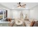 Spacious living room showcasing neutral tones, modern ceiling fan, and staircase view at 11035 W Lakeshore Dr, Carmel, IN 46033