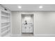 Basement wet bar area featuring a sink, light, cabinet storage, and shelving at 11035 W Lakeshore Dr, Carmel, IN 46033