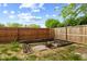 Backyard firepit with a wood retaining wall and a wooden fence at 1135 Sherwood Dr, Danville, IN 46122