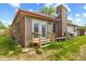 Back exterior elevation, showing access from the house to the backyard and a brick chimney at 1135 Sherwood Dr, Danville, IN 46122