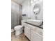 Bathroom featuring a vessel sink on a vanity cabinet with dark stone countertop and a decorative mirror at 1135 Sherwood Dr, Danville, IN 46122