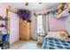 bedroom with lilac walls, blue plaid bed set, and lots of toys at 1135 Sherwood Dr, Danville, IN 46122