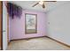 This bedroom features neutral carpet, a window, and lilac paint at 1135 Sherwood Dr, Danville, IN 46122