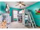 Vibrant bedroom with teal walls, a loft bed, ceiling fan and carpeted floor at 1135 Sherwood Dr, Danville, IN 46122