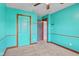 A teal bedroom features carpet, two tone walls, ceiling fan, two closets and neutral trim at 1135 Sherwood Dr, Danville, IN 46122