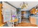 Bright dining area with hardwood floors, complemented by a vintage light fixture at 1135 Sherwood Dr, Danville, IN 46122
