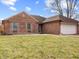 Charming brick home featuring a well-manicured lawn and attached garage at 1135 Sherwood Dr, Danville, IN 46122