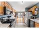 Traditional-style kitchen with stainless steel appliances, wood cabinets, and a view into another room with glass french doors at 1135 Sherwood Dr, Danville, IN 46122