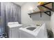 Functional laundry room featuring a modern washer and dryer with storage shelves for laundry essentials at 1135 Sherwood Dr, Danville, IN 46122