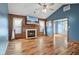 Cozy living room with hardwood floors, a fireplace, and bright windows at 1135 Sherwood Dr, Danville, IN 46122