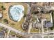 Aerial view of a beautiful home with a pond, a large lawn, and mature trees in winter at 13139 Dumbarton St, Carmel, IN 46032