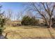 Large, grassy backyard with mature trees and a black iron fence at 13139 Dumbarton St, Carmel, IN 46032