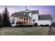 Rear exterior showcasing the home's backyard and gazebo at dusk at 13139 Dumbarton St, Carmel, IN 46032