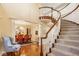 Elegant foyer featuring a grand staircase, high ceilings, and a view into the formal dining room at 13139 Dumbarton St, Carmel, IN 46032