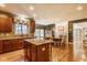 Bright kitchen showcasing stainless steel appliances, granite countertops, a large island, and open layout to the dining area at 13139 Dumbarton St, Carmel, IN 46032