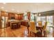 Spacious kitchen features stainless steel appliances, wood cabinets, granite counters, island, and attached dining area at 13139 Dumbarton St, Carmel, IN 46032