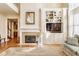 Well-lit living room with fireplace, built-in shelving, and beautiful views at 13139 Dumbarton St, Carmel, IN 46032