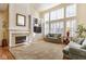 Bright living room with high ceilings, large windows, fireplace, and built-in shelving at 13139 Dumbarton St, Carmel, IN 46032
