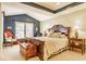 Beautiful primary bedroom boasts a vaulted ceiling, large window, and cozy sitting area at 13139 Dumbarton St, Carmel, IN 46032