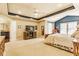 Large main bedroom with tray ceilings, a ceiling fan, carpet, and an attached ensuite bathroom at 13139 Dumbarton St, Carmel, IN 46032