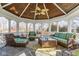 Bright sunroom with wicker furniture, vaulted wood ceiling, and great natural light at 13139 Dumbarton St, Carmel, IN 46032