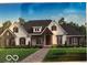 Charming single-story home with a combination of stone and siding, complemented by a neatly landscaped yard and brick walkway at 14338 Laura Vista Dr, Carmel, IN 46033
