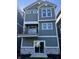 Striking new home with a balcony, sliding glass door, and stylish exterior finishes at 15403 Mystic Rock Dr, Carmel, IN 46033