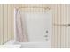 Bathroom shower with a patterned curtain in a room with striped walls at 17223 Gunther Blvd # 310, Westfield, IN 46074