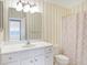 Bright bathroom with a vanity, mirror, and shower with striped walls at 17223 Gunther Blvd # 310, Westfield, IN 46074