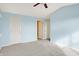 This neutrally painted and carpeted bedroom boasts three doors and a ceiling fan, and is ready for a personalized touch at 17223 Gunther Blvd # 310, Westfield, IN 46074