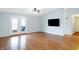 Bright living room with hardwood floors, access to a balcony, and a modern ceiling fan at 17223 Gunther Blvd # 310, Westfield, IN 46074