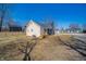 A wide view of the back of the home with the deck and large open yard at 227 W 7Th St, Lapel, IN 46051