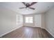 Bright bedroom with ceiling fan, wood floors, and built-in shelves for storage at 227 W 7Th St, Lapel, IN 46051