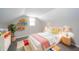 Bright bedroom featuring vaulted ceilings, colorful decor, and comfortable furnishings at 227 W 7Th St, Lapel, IN 46051