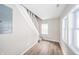 Entryway area, with new floors and fresh paint leading up to the stairs at 227 W 7Th St, Lapel, IN 46051