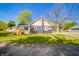 Charming home with a well-manicured lawn, complemented by mature trees and blue skies at 227 W 7Th St, Lapel, IN 46051