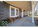 Inviting front porch with seating, ideal for relaxing and enjoying the outdoors at 227 W 7Th St, Lapel, IN 46051