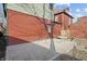 View of backyard with a concrete patio, door to house, and potential garden area at 235 E 11Th St, Indianapolis, IN 46202