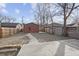 View of a spacious backyard with a concrete patio, walkway, shed, and wooden fence at 235 E 11Th St, Indianapolis, IN 46202