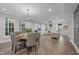 Bright dining area flowing into an open living room with multiple windows at 235 E 11Th St, Indianapolis, IN 46202