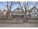 Charming red brick two-story home with a welcoming front porch and professionally landscaped front yard at 235 E 11Th St, Indianapolis, IN 46202